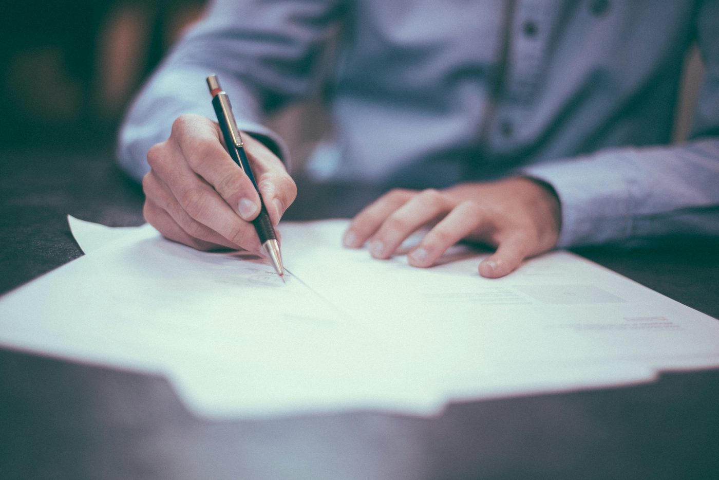 Signing a document at a desk